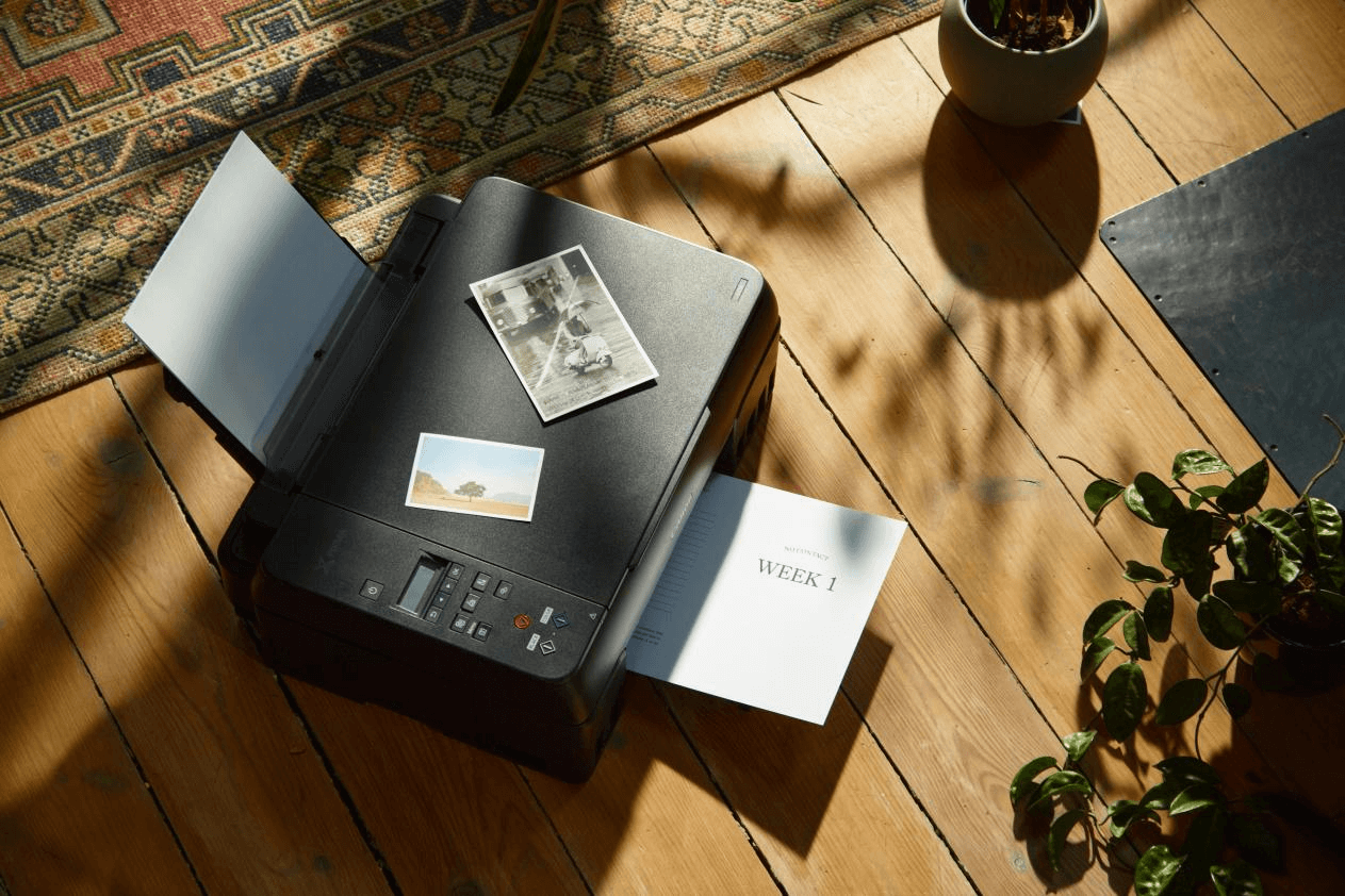 A modern inkjet printer in a home office setting.
