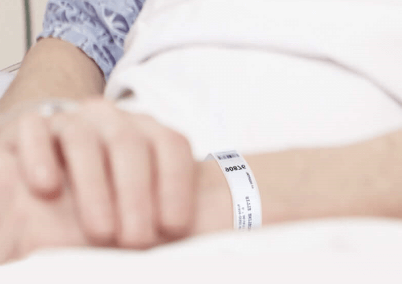 Nurse attending to a patient with a medical wristband